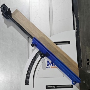 May include: A woodworking tool with a blue guide and a wooden plank. The tool is white with black markings and the text "MK TOOLS". The image also includes a truck with the words "FREE SHIPPING".
