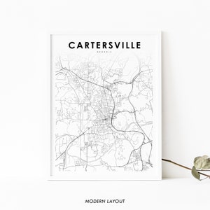 May include: A black and white line art map of Cartersville, Georgia. The map shows the city's streets and roads, as well as some of its landmarks. The text "Cartersville, Georgia" and "Modern Layout" are printed below the map.