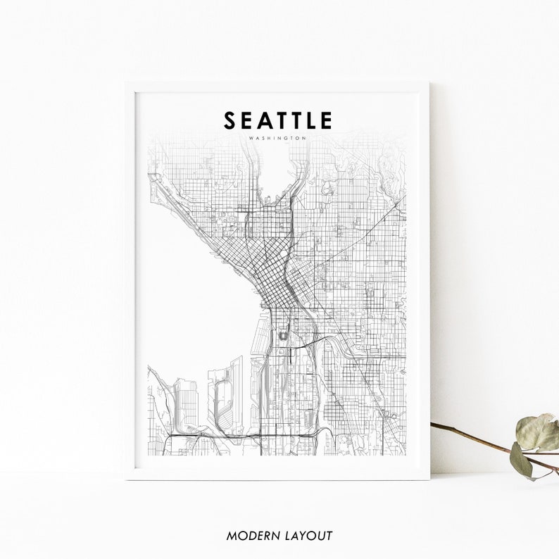 May include: A black and white line art map of Seattle, Washington. The map shows the city's streets and major landmarks. The text "Seattle" and "Washington" are printed in black at the top of the map. The text "Modern Layout" is printed in black at the bottom of the map.