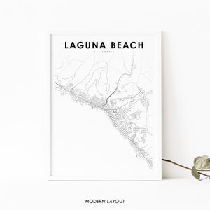 May include: A framed black and white map print of Laguna Beach, California. The map details the city's layout with roads and geographical features. The text "LAGUNA BEACH" and "CALIFORNIA" are at the top, with "MODERN LAYOUT" at the bottom.
