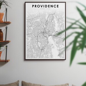 May include: A black and white map print of Providence, Rhode Island, in a black frame. The map shows the city streets and waterways. The title "PROVIDENCE RHODE ISLAND" is printed at the top of the map.