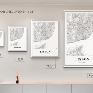 May include: A mockup of four different sizes of a black and white map print of Lisbon, Portugal. The prints are framed in white and are displayed on a white wall. The sizes are 8x10 inches, 12x16 inches, 18x24 inches, and 24x36 inches.