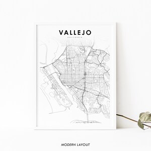 May include: A black and white line art map of Vallejo, California. The map shows the city's streets and waterways. The text "VALLEJO" and "CALIFORNIA" are printed above the map. The text "MODERN LAYOUT" is printed below the map.
