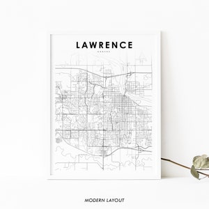 May include: Black and white line art map of Lawrence, Kansas. The map shows the city's streets and roads. The text "LAWRENCE" and "KANSAS" is printed at the top of the map. The text "MODERN LAYOUT" is printed at the bottom of the map.