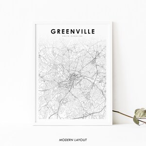 以下が含まれることがあります： サウスカロライナ州グリーンビルの白黒地図プリント。地図には、市の通りとランドマークが表示されています。地図の上部には「グリーンビル、サウスカロライナ」というタイトルが印刷されています。地図の下部には「モダンレイアウト」という文字が印刷されています。