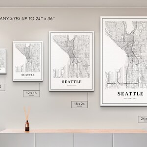 May include: Four different sizes of a black and white line art print of the city of Seattle, Washington. The print is available in sizes 8x10 inches, 12x16 inches, 18x24 inches, and 24x36 inches.
