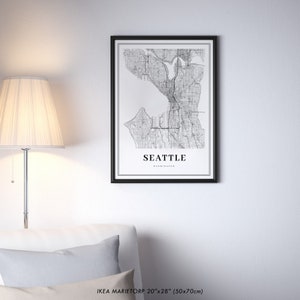 May include: Black and white map print of Seattle, Washington in a black frame. The print is 20 inches by 28 inches (50 cm by 70 cm).
