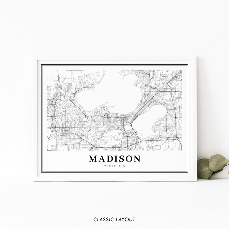 May include: Black and white line art map of Madison, Wisconsin. The map shows the city's streets, lakes, and other geographic features. The text "MADISON" and "WISCONSIN" is printed below the map.