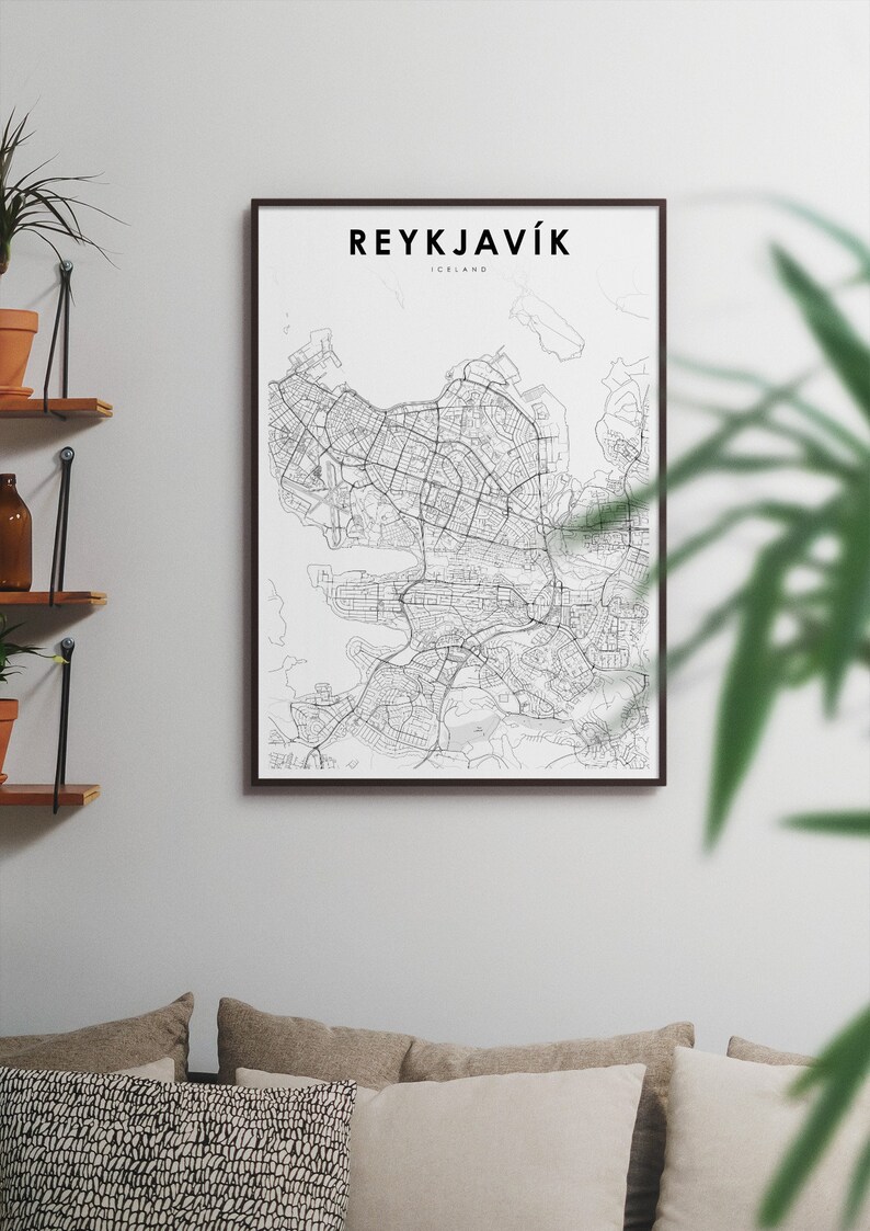 May include: A black and white map print of Reykjavik, Iceland, in a black frame. The map shows the city's streets and waterways. The title "REYKJAV&Iacute;K" is printed in black at the top of the map.