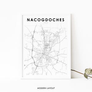 May include: A framed black and white map print of Nacogdoches, Texas. The city name is displayed in a bold, sans-serif font at the top, with "Texas" below. The words "Modern Layout" are at the bottom.