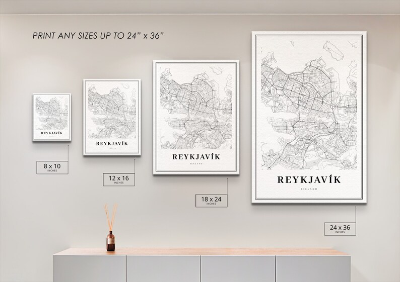 May include: Four different sizes of a black and white map print of Reykjavik, Iceland. The prints are framed in white and are displayed on a white wall. The sizes are 8x10 inches, 12x16 inches, 18x24 inches, and 24x36 inches.