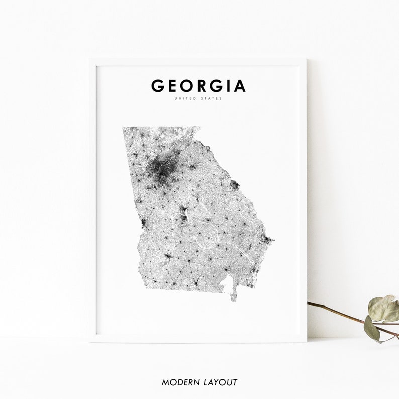 May include: A black and white map of the state of Georgia, United States. The map shows the location of cities and towns throughout the state. The title "GEORGIA" and "UNITED STATES" are printed in black at the top of the map. The words "MODERN LAYOUT" are printed in black at the bottom of the map.