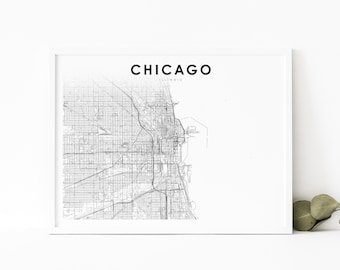 May include: A framed black and white map of Chicago, Illinois. The city name is printed in a bold, sans-serif font above the map. The words "Modern Layout" are printed at the bottom of the frame.
