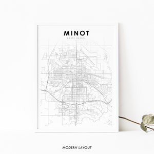 May include: A black and white map of Minot, North Dakota, with the city name and state printed at the top. The map is framed in a white frame and has the text "MODERN LAYOUT" printed below the map.