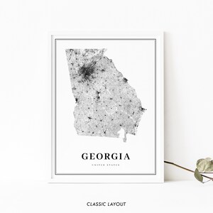 May include: Black and white map print of the state of Georgia, United States. The map shows the population density of the state. The text "GEORGIA" and "UNITED STATES" is printed below the map.