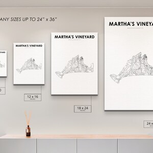 May include: A white wall with four framed prints of a black and white map of Martha's Vineyard. The prints are in different sizes: 8x10 inches, 12x16 inches, 18x24 inches, and 24x36 inches. The text "PRINT ANY SIZES UP TO 24" x 36" is at the top of the wall. The text "MARTHA'S VINEYARD" is at the top of each print.