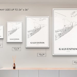 May include: Four different sizes of a black and white map print of Galveston, Texas. The prints are framed in white and are displayed on a white wall. The sizes are 8x10 inches, 12x16 inches, 18x24 inches, and 24x36 inches.