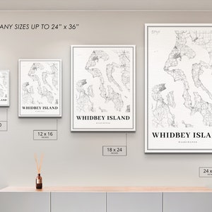 May include: A wall display showing different sizes of a black and white map print of Whidbey Island, Washington. The print sizes are 8x10 inches, 12x16 inches, 18x24 inches, and 24x36 inches.