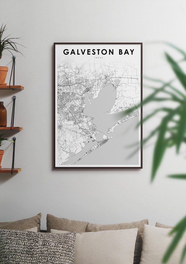 May include: A black and white map print of Galveston Bay, Texas, in a brown frame. The map shows the coastline and surrounding area.