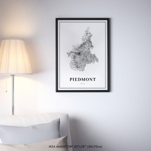 May include: A black and white map print of the Piedmont region of Italy in a black frame. The map is a detailed illustration of the region's roads and cities. The print is labeled "Piedmont, Italy" and is 20 inches by 28 inches (50x70 cm).