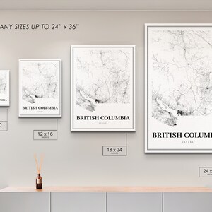May include: Four different sizes of a black and white map print of British Columbia, Canada. The prints are framed in white and are displayed on a light grey wall. The sizes are 8x10 inches, 12x16 inches, 18x24 inches, and 24x36 inches.