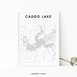 May include: A black and white map print of Caddo Lake, Texas & Louisiana. The map shows the lake and surrounding area with roads and other features. The text "CADDO LAKE" and "MODERN LAYOUT" are printed below the map.
