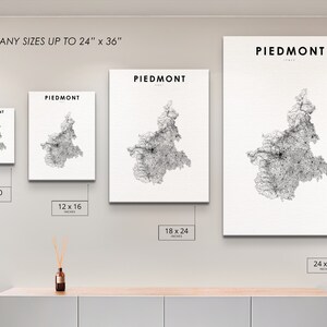 May include: A wall display showing different sizes of a black and white map print of Piedmont, Italy. The print sizes are 8x10 inches, 12x16 inches, 18x24 inches, and 24x36 inches.