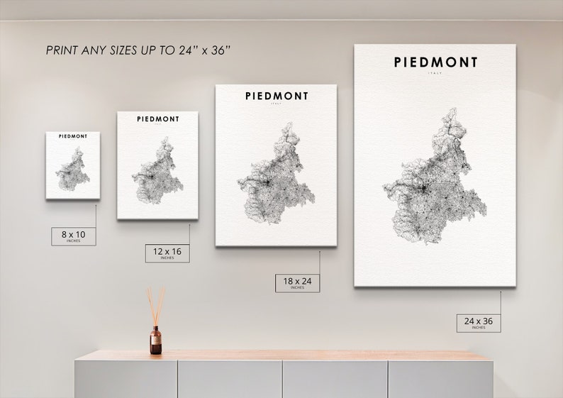 May include: A wall display showing different sizes of a black and white map print of Piedmont, Italy. The print sizes are 8x10 inches, 12x16 inches, 18x24 inches, and 24x36 inches.