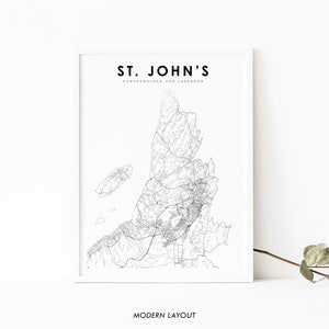 May include: Black and white line art map of St. John's, Newfoundland and Labrador. The map shows the city's streets and roads. The text "ST. JOHN'S" and "NEWFOUNDLAND AND LABRADOR" is at the top of the map. The text "MODERN LAYOUT" is at the bottom of the map.