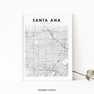 May include: A black and white map print of Santa Ana, California. The map shows the city's streets and roads. The title "SANTA ANA" and "CALIFORNIA" are printed at the top of the map. The words "MODERN LAYOUT" are printed at the bottom of the map.