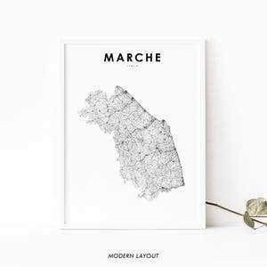 May include: A black and white line art map of the Marche region of Italy. The map is surrounded by a white border and the word "MARCHE" is printed in black at the top of the map. The words "ITALY" are printed in smaller black font below the word "MARCHE". The words "MODERN LAYOUT" are printed in black at the bottom of the map.