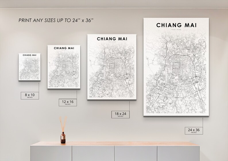 May include: A white wall with four different sized prints of a black and white map of Chiang Mai, Thailand. The prints are 8x10 inches, 12x16 inches, 18x24 inches, and 24x36 inches.