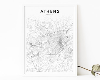 May include: A black and white map of Athens, Georgia, with the city name and state printed at the top. The map is framed in a white frame and has a modern layout.
