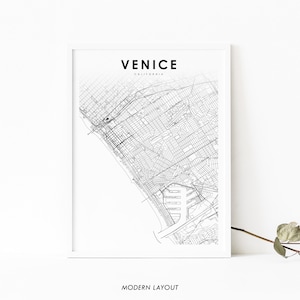 May include: A black and white map print of Venice, California. The map shows the streets and waterways of the city. The title "Venice, California" is printed at the top of the map. The words "Modern Layout" are printed at the bottom of the map.