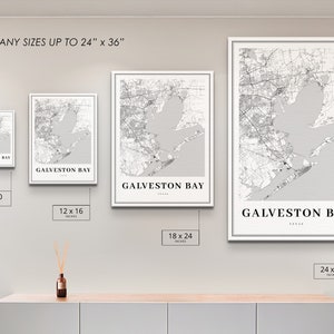 May include: Four different sizes of a black and white map print of Galveston Bay, Texas. The prints are framed in white and displayed on a wall. The sizes are 8x10 inches, 12x16 inches, 18x24 inches, and 24x36 inches.