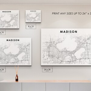 May include: A white canvas print of a map of Madison, Wisconsin. The map shows the city's streets, lakes, and other features. The print is available in various sizes, up to 24 inches by 36 inches.