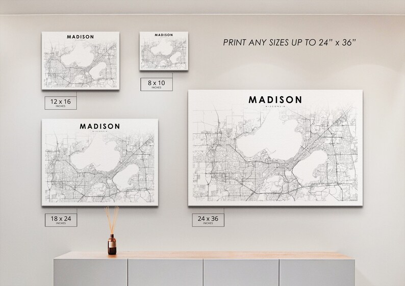 May include: A white canvas print of a map of Madison, Wisconsin. The map shows the city's streets, lakes, and other features. The print is available in various sizes, up to 24 inches by 36 inches.