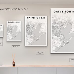 May include: A wall display showing different sizes of a black and white map print of Galveston Bay, Texas. The print sizes are 8x10 inches, 12x16 inches, 18x24 inches, and 24x36 inches. The text "PRINT ANY SIZES UP TO 24" x 36" is at the top of the image.