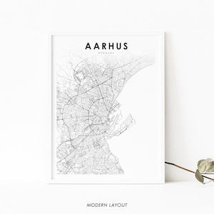 May include: A black and white line art map of Aarhus, Denmark. The map shows the city's streets and waterways. The text "AARHUS" and "DENMARK" is printed above the map. The text "MODERN LAYOUT" is printed below the map.