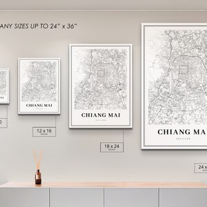 May include: Four different sizes of a black and white map print of Chiang Mai, Thailand. The prints are displayed on a wall with a white background. The sizes are 8x10 inches, 12x16 inches, 18x24 inches, and 24x36 inches.
