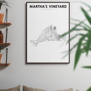 May include: A black and white line art print of Martha's Vineyard, Massachusetts. The print is framed in a black frame and is hanging on a white wall.