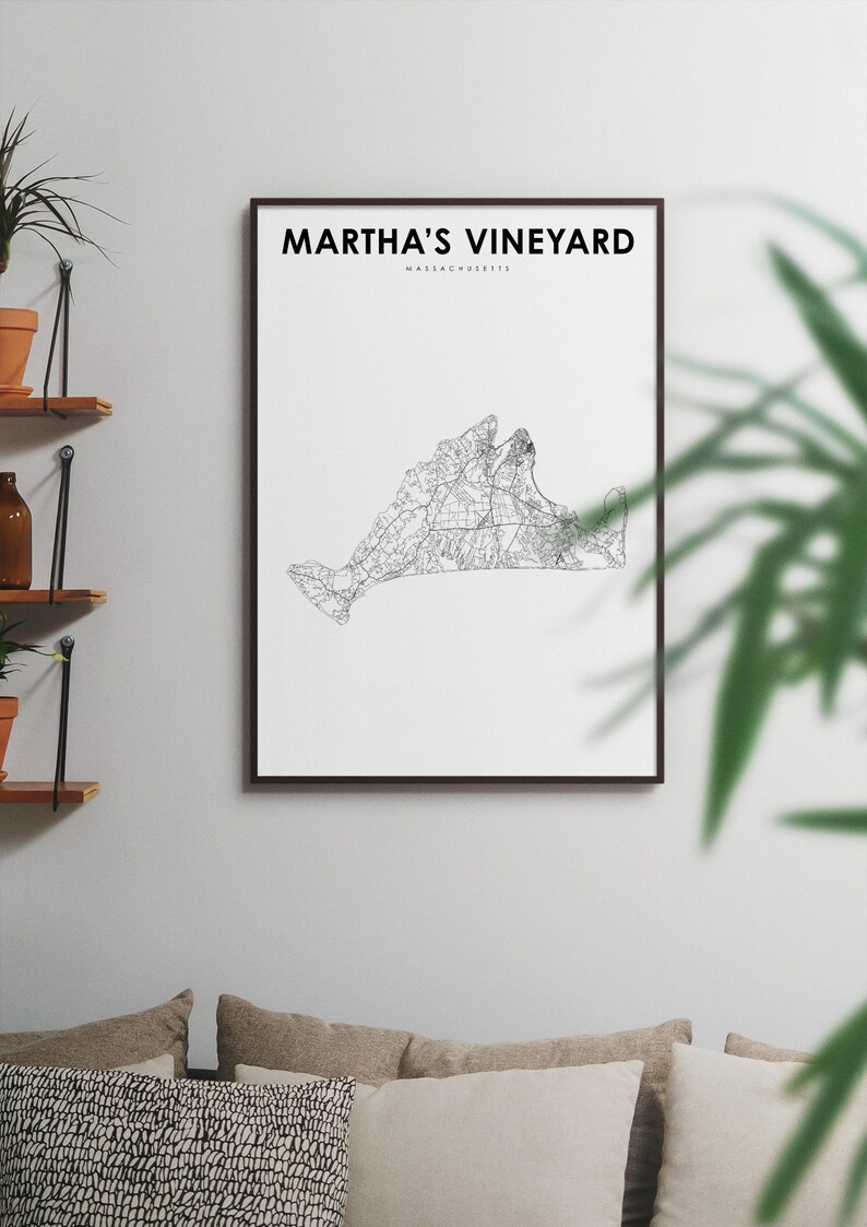 May include: A black and white line art print of Martha's Vineyard, Massachusetts. The print is framed in a black frame and is hanging on a white wall.