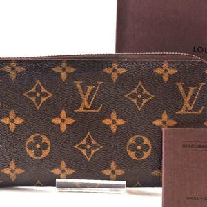 Cartera larga de piel con cremallera y monograma de Louis Vuitton, usada y con estuche