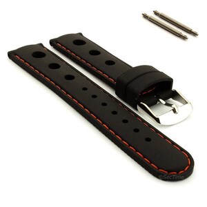 May include: A black rubber watch strap featuring orange contrast stitching and a series of circular perforations along the length. The strap includes a polished silver-tone metal buckle and two matching metal spring bars for attachment.