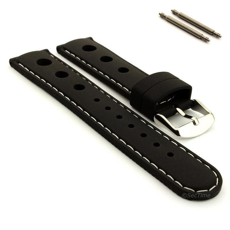 May include: A black watch strap featuring a perforated design with large circular holes near the lug end and smaller holes for the buckle. The strap has white contrast stitching along the edges and a polished silver-tone metal buckle and two spring bars.