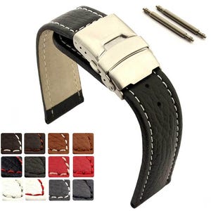 Pode incluir: Uma pulseira de relógio preta texturizada com costuras brancas em contraste e um fecho de báscula em metal prateado. Dois pinos de mola em metal estão incluídos. Uma grelha de doze pequenas amostras de cor mostra várias opções disponíveis.