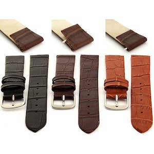 May include: Three watch straps in black, brown, and tan leather with a crocodile pattern. The straps have silver buckles.