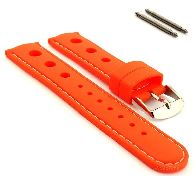 May include: A bright orange silicone watch strap featuring a perforated design with white contrast stitching along the edges. The strap includes a polished silver-tone metal buckle and two matching spring bars positioned separately above the band.