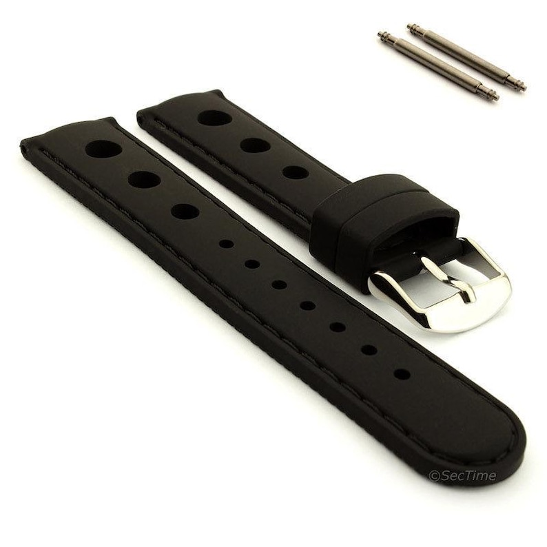 May include: A black rubber watch strap featuring a perforated design with circular holes along the length, a silver-toned metal buckle, and two matching metal spring bars positioned separately above the strap components.
