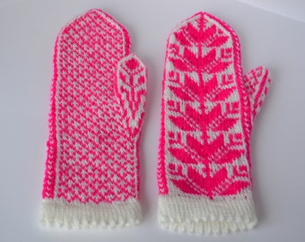 May include: A pair of pink and white knitted mittens with different patterns. One mitten has a geometric pattern and the other has a floral pattern.